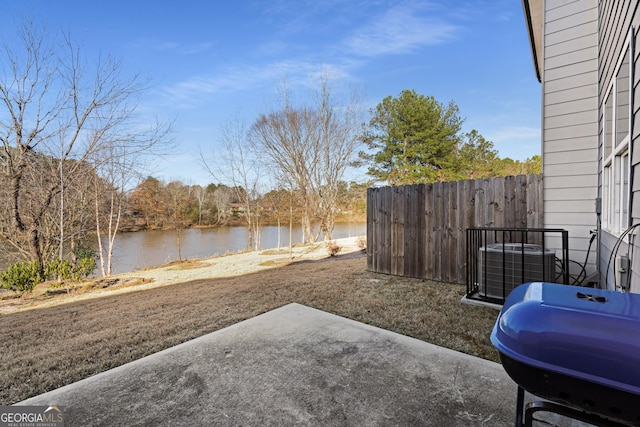 view of yard with a water view, central AC unit, and a patio area