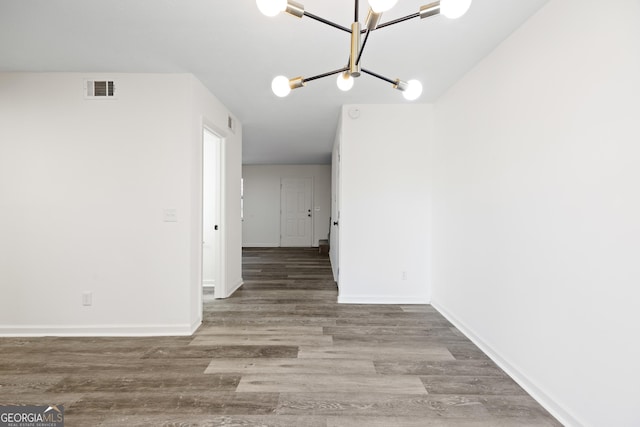 hallway featuring a chandelier and hardwood / wood-style floors