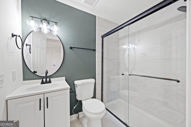 bathroom with vanity, toilet, and an enclosed shower