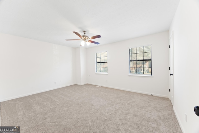 unfurnished room with ceiling fan and light colored carpet