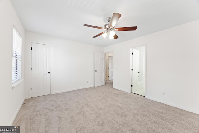 spare room with light colored carpet and ceiling fan