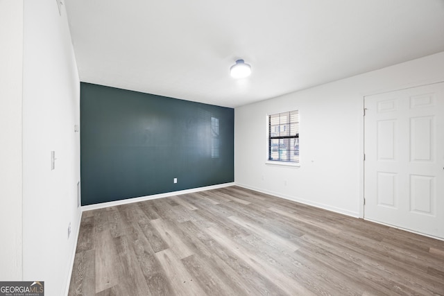 empty room with light hardwood / wood-style flooring