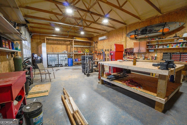 garage featuring a workshop area and an AC wall unit