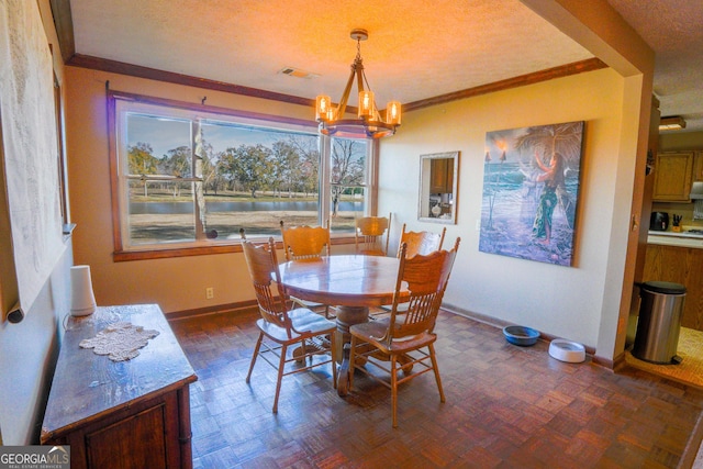 dining room with a notable chandelier, dark parquet flooring, a textured ceiling, and crown molding