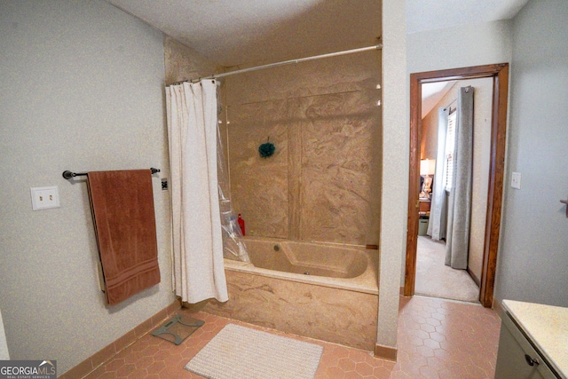 bathroom featuring tile patterned floors, shower / bath combo, and vanity