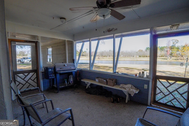 sunroom / solarium featuring ceiling fan and plenty of natural light