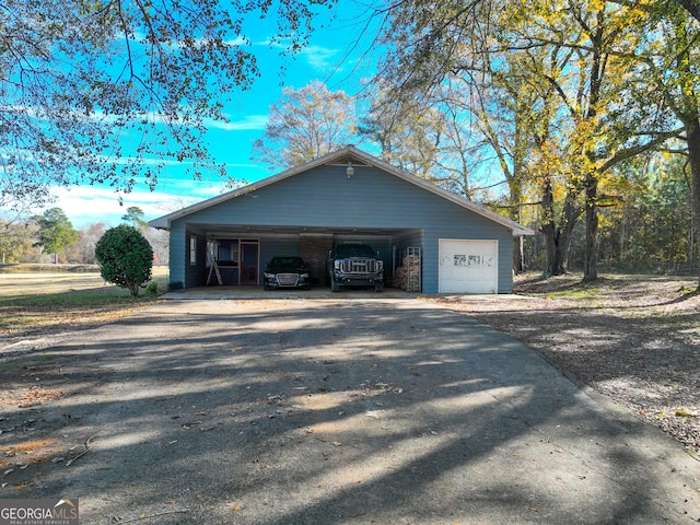 view of side of home featuring a carport and a garage