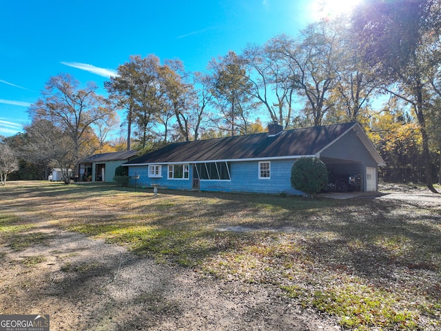 view of property exterior featuring a lawn and a garage