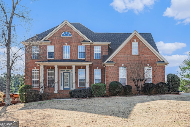 view of front of property featuring brick siding and a shingled roof