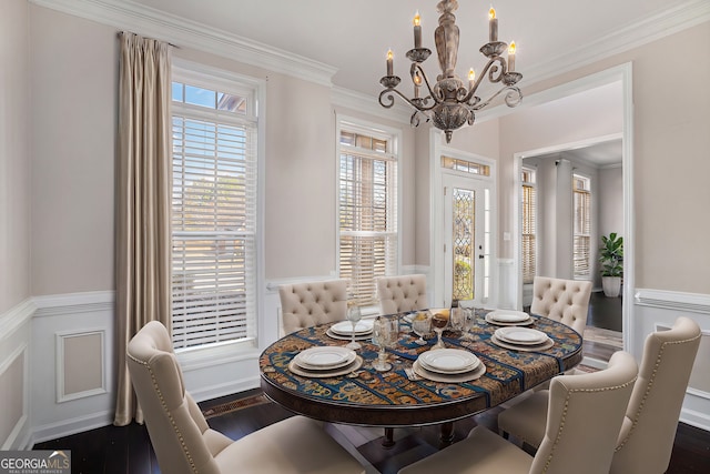 dining area featuring wood finished floors, an inviting chandelier, and ornamental molding