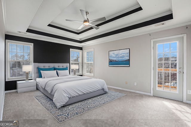 bedroom with access to exterior, visible vents, and a tray ceiling