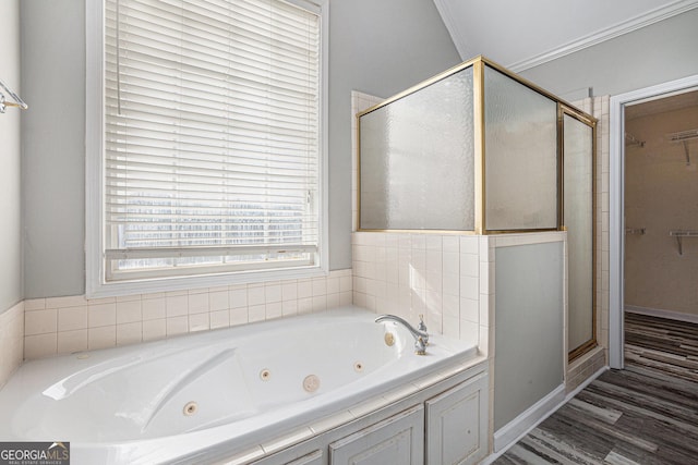bathroom featuring wood finished floors, a jetted tub, a stall shower, and ornamental molding