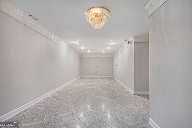 unfurnished room with visible vents, a notable chandelier, marble finish floor, ornamental molding, and baseboards