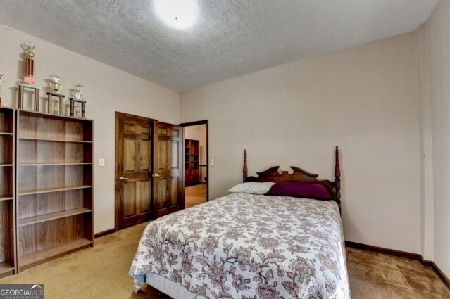 carpeted bedroom featuring a textured ceiling