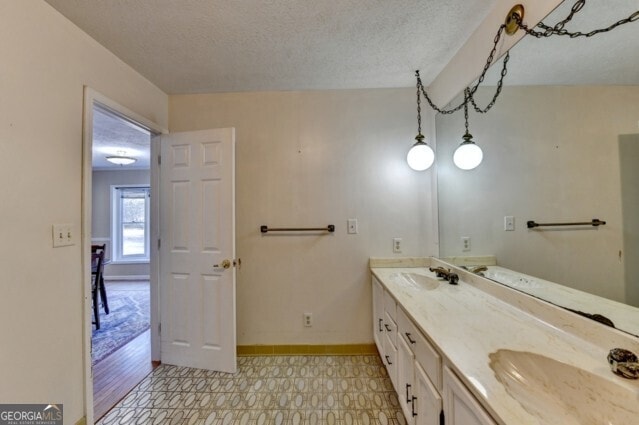 bathroom with vanity and a textured ceiling