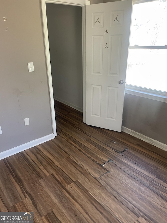 empty room with dark wood-type flooring