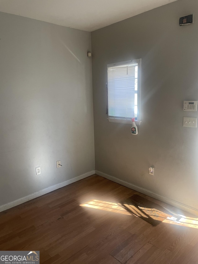 spare room with dark wood-type flooring