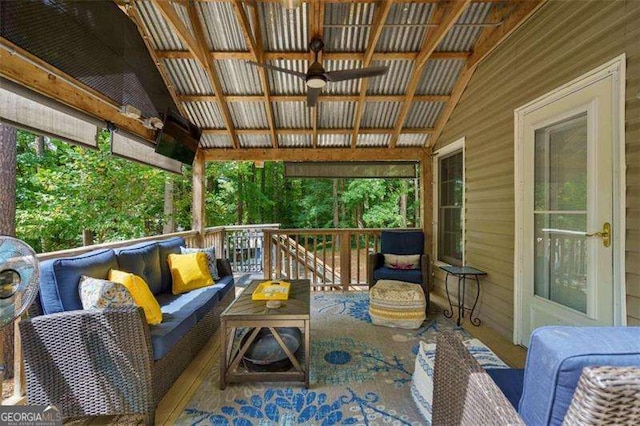 exterior space featuring ceiling fan, a deck, and an outdoor living space