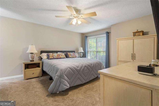 carpeted bedroom with a textured ceiling and ceiling fan