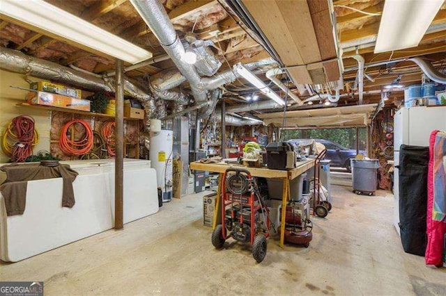 basement with a workshop area and water heater