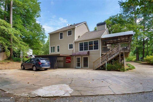 back of property with a carport