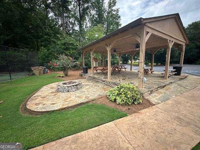 exterior space with a gazebo and a fire pit