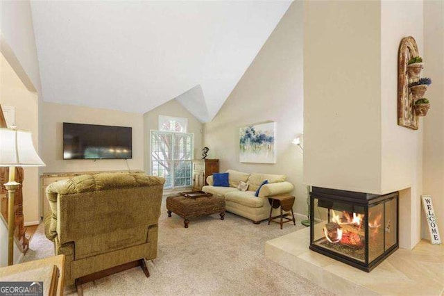 living room with light colored carpet and vaulted ceiling