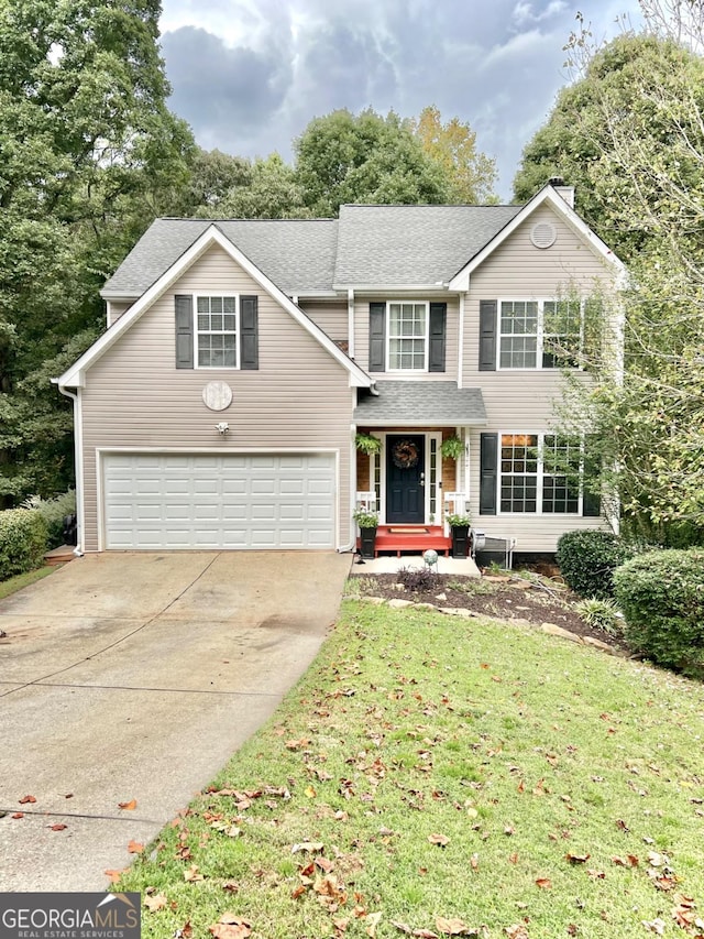 front facade featuring a front yard and a garage