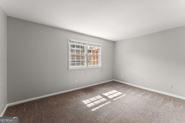 unfurnished bedroom featuring carpet and ensuite bath