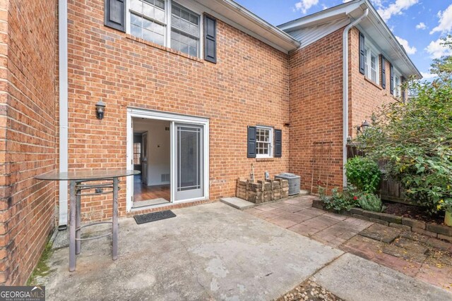 back of house featuring a patio area and central air condition unit