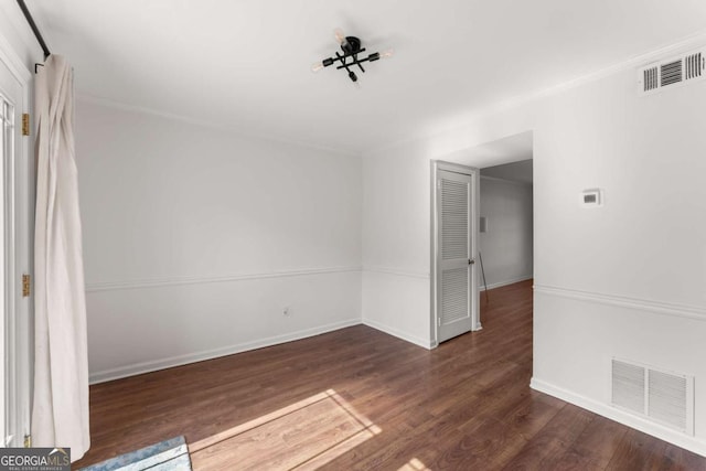 unfurnished room with dark hardwood / wood-style flooring