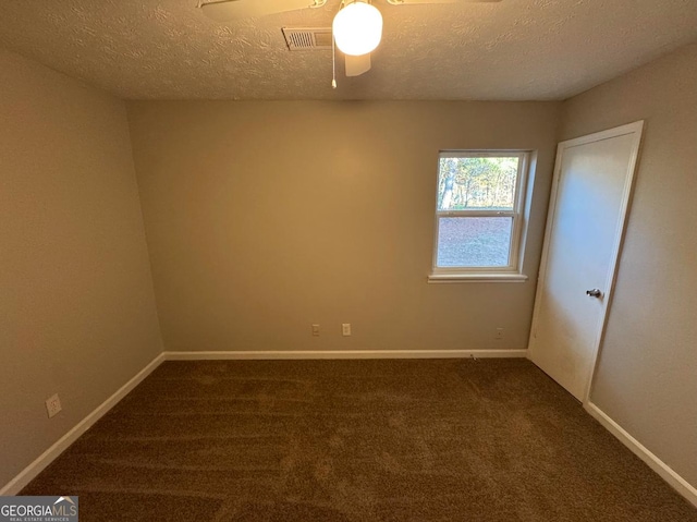 carpeted empty room with ceiling fan and a textured ceiling