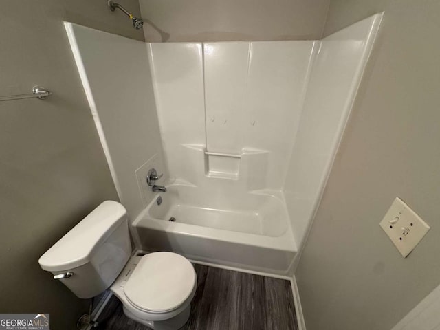 bathroom with toilet, bathtub / shower combination, and hardwood / wood-style flooring