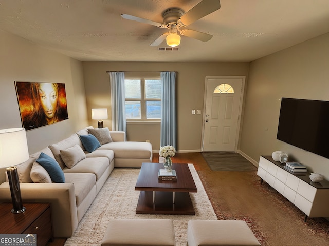 living room featuring ceiling fan and hardwood / wood-style floors