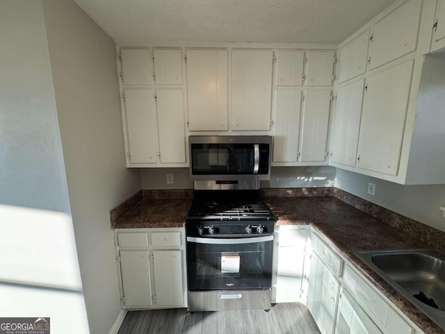 kitchen with white cabinetry and stainless steel appliances