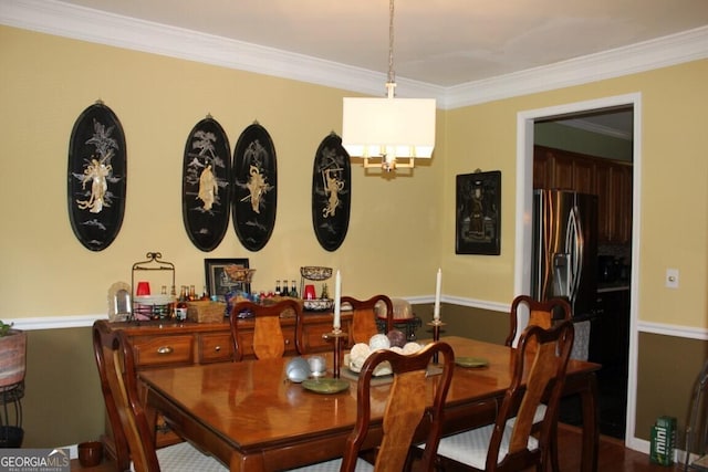 dining room featuring crown molding