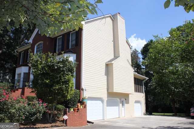 view of side of home with a garage