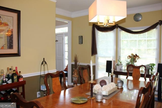 dining space featuring crown molding