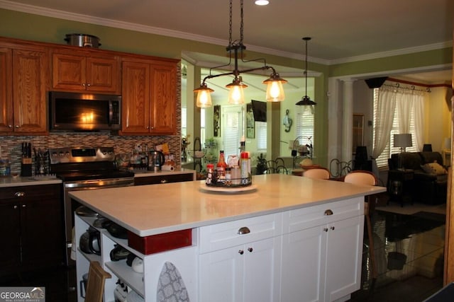 kitchen featuring white cabinets, decorative backsplash, electric range, and hanging light fixtures