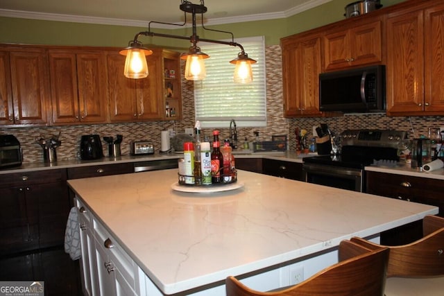 kitchen with electric range, a kitchen breakfast bar, backsplash, crown molding, and a kitchen island