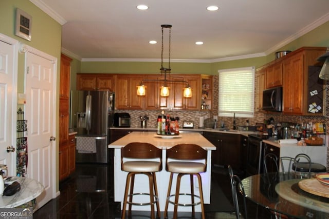 kitchen featuring tasteful backsplash, crown molding, pendant lighting, stainless steel fridge with ice dispenser, and a center island