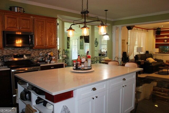 kitchen featuring decorative backsplash, appliances with stainless steel finishes, white cabinetry, and ornamental molding