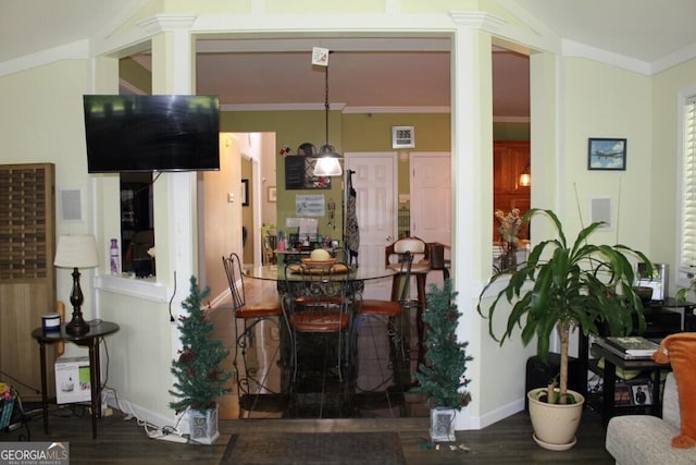 dining space with crown molding and dark wood-type flooring