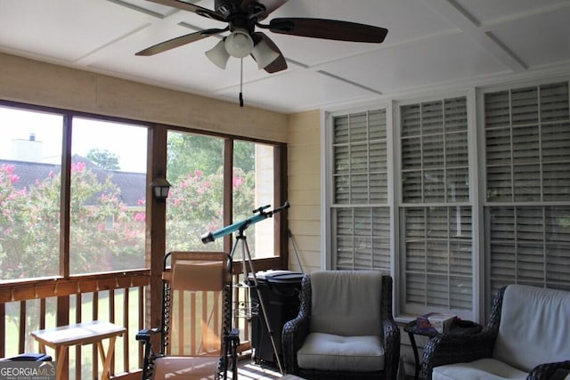 sunroom featuring ceiling fan