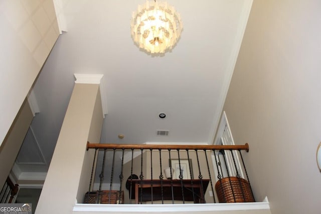 stairway featuring a chandelier