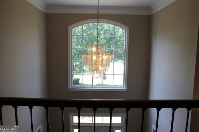 details with ornamental molding and a chandelier