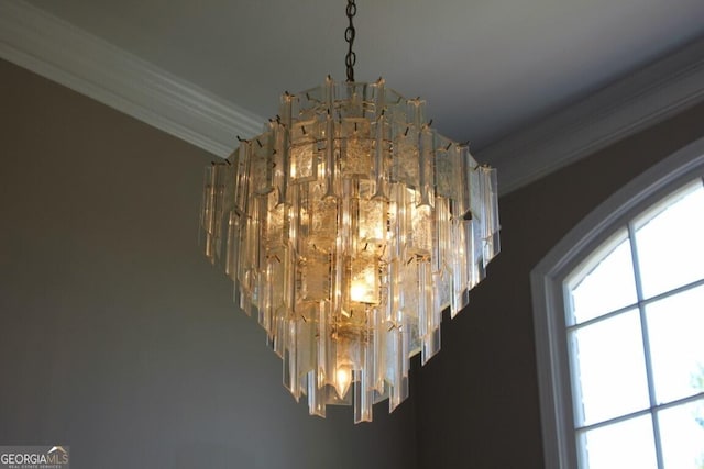 interior details featuring crown molding and a chandelier