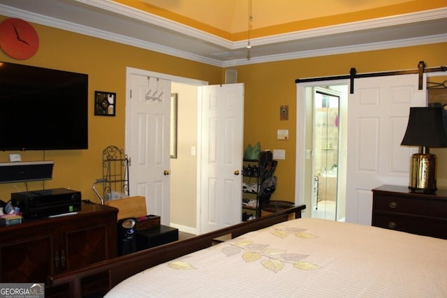 bedroom with a barn door and crown molding