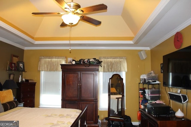 bedroom with a tray ceiling, crown molding, and ceiling fan