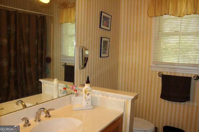 bathroom with a shower with curtain, vanity, and toilet